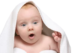 Adorable Baby Wrapped in White Towel with Surprised Expression and Wide Eyes