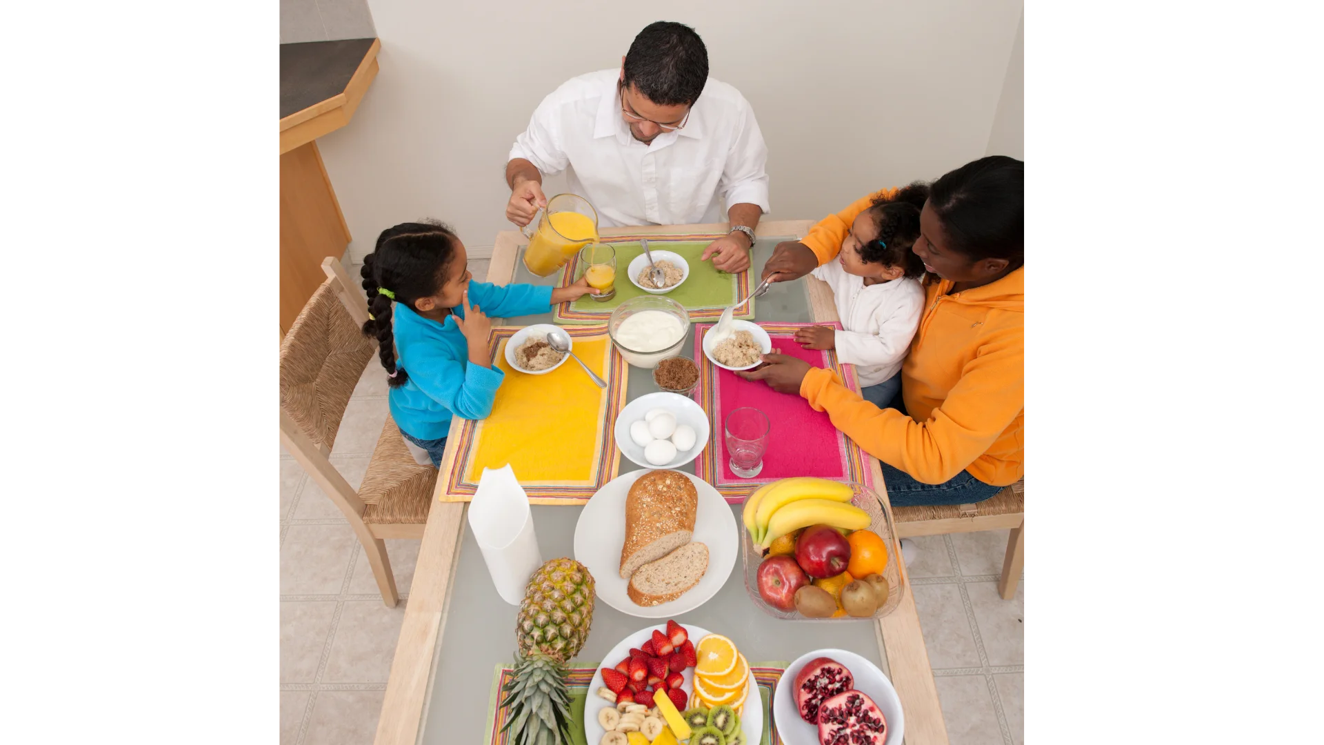 Cheerful Family Gathering Around Dinner Table Enjoying Meal Preparation Clipart